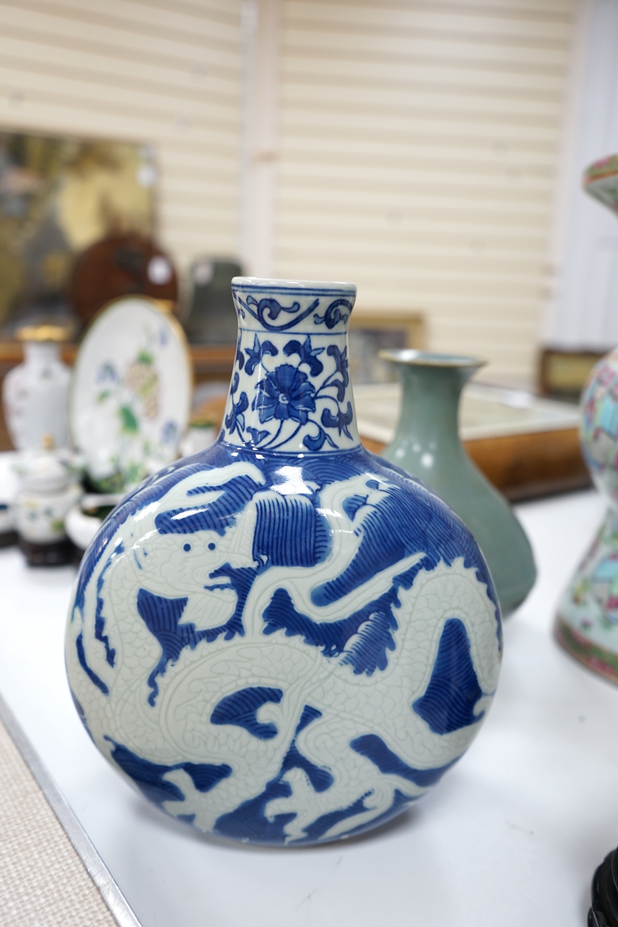 A large 19th century Chinese famille rose vase, a green glazed pear-shaped vase, and a blue and white dragon flask (3). Condition - poor to fair.